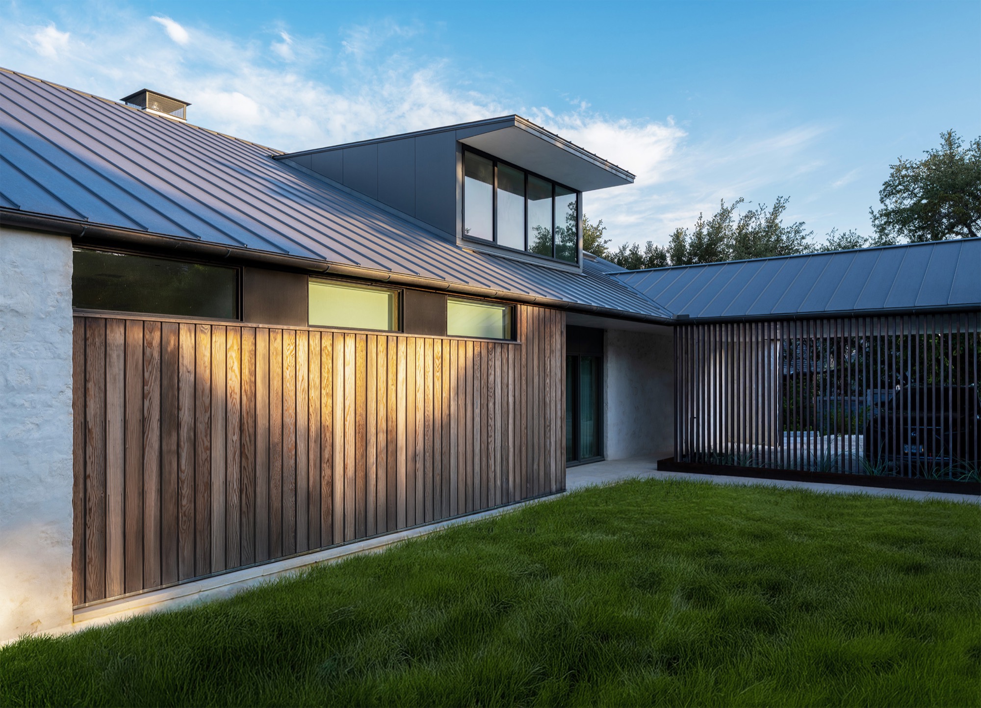 Hillside House exterior with custom slat screen in West Lake Hills, Texas